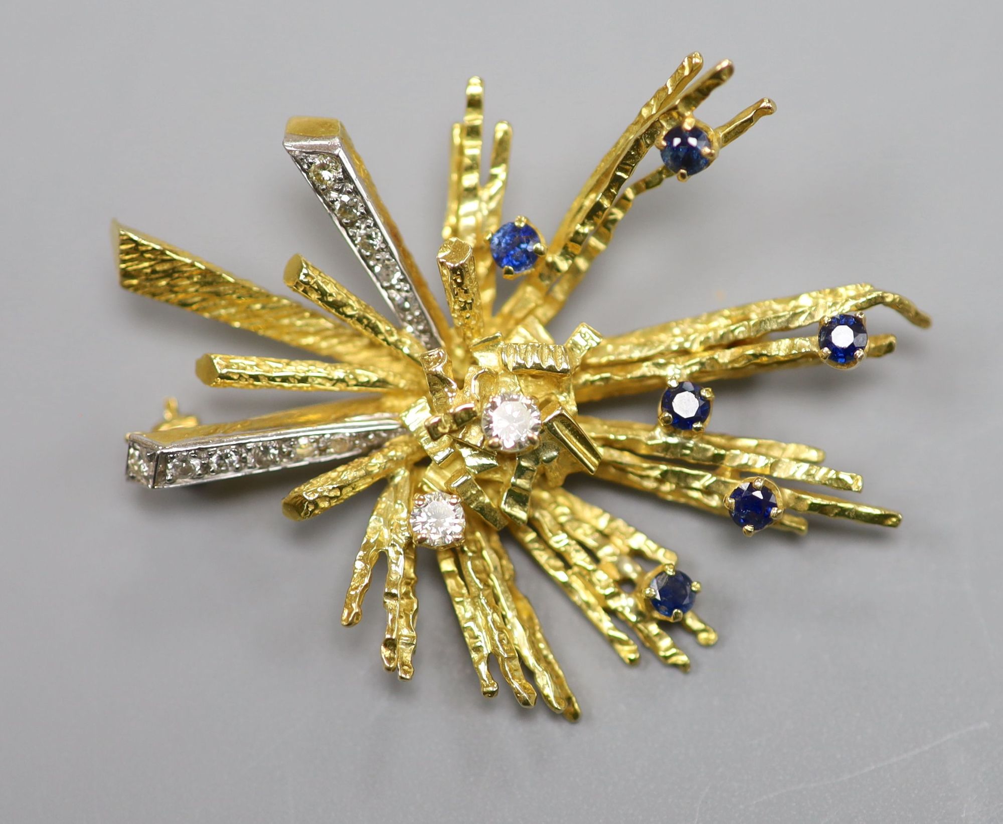 A late 1960s 18ct gold, sapphire and diamond set modernist spray brooch, 48mm, gross 16.5 grams,